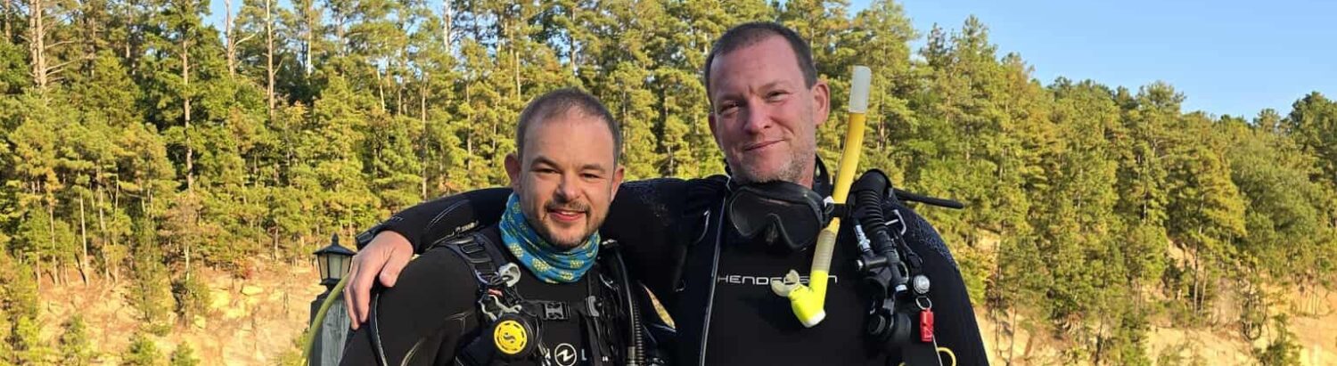 DiveWithFrank and Divemaster Anthony in full scuba gear on a dock at Lake Phoenix