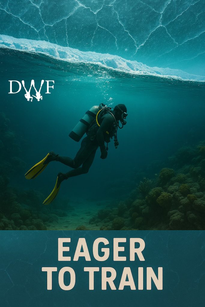 Scuba diver swimming under frozen surface with text ‘Eager to Train’