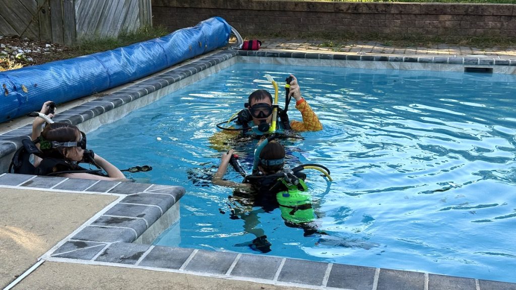 Divers finishing their session with surface skills and smiles all around.