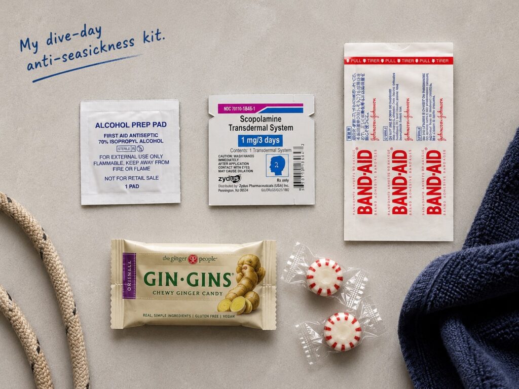 Flat lay photo of a scuba diver’s anti-seasickness kit including a scopolamine patch, alcohol prep pad, waterproof bandage, ginger chews, and peppermint candies.