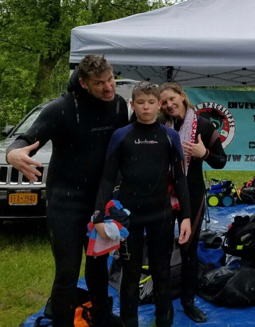 Parents and their teenage diver sharing a lighthearted moment during a Zombie Apocalypse Diver weekend.