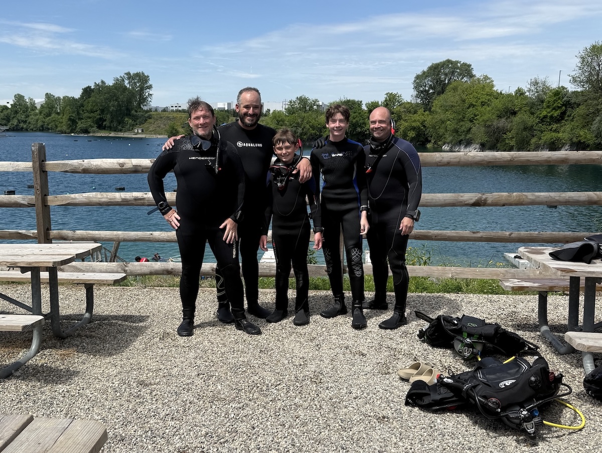 Newly certified Advanced Open Water divers celebrating after completing training at Lake Hydra