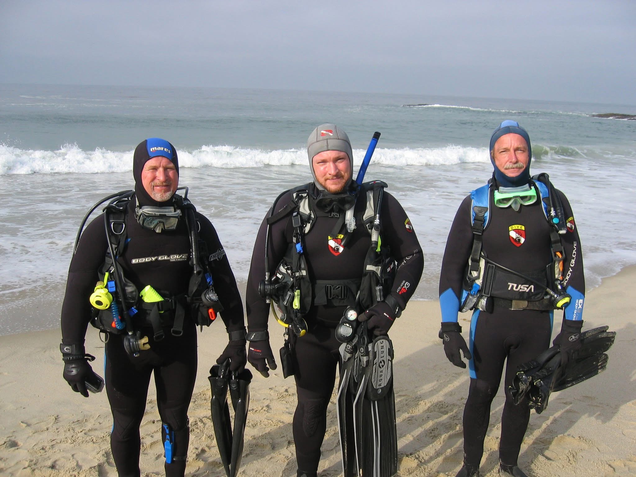 Group of scuba divers preparing for a beach dive in Southern California.